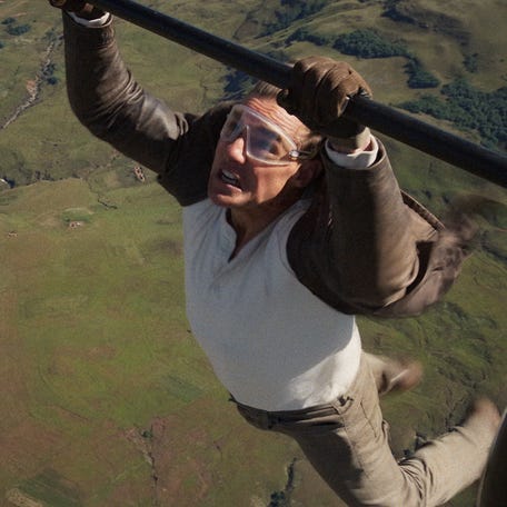 Ethan Hunt (Tom Cruise) holds onto a biplane for dear life in "Mission: Impossible – The Final Reckoning."