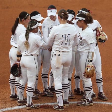 Texas A&M teammates meet on the mound during a game against Texas in the SEC Tournament on May 9, 2025.