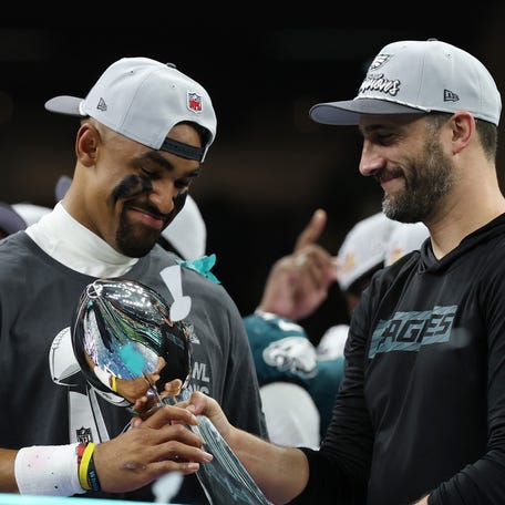 Feb 9, 2025; New Orleans, LA, USA; Philadelphia Eagles quarterback Jalen Hurts holds the Lombardi Trophy while standing next to Eagles head coach Nick Sirianni (R) during the championship trophy presentation. Mandatory Credit: Geoff Burke-Imagn Images
