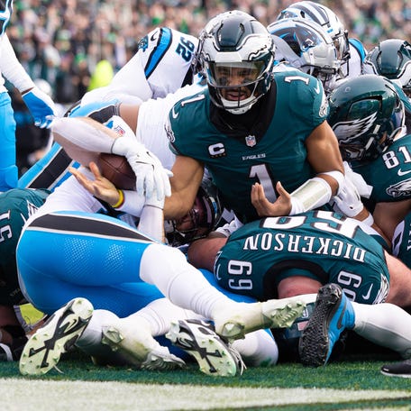 Dec 8, 2024; Philadelphia, Pennsylvania, USA; Philadelphia Eagles quarterback Jalen Hurts (1) reacts after scoring against the Carolina Panthers during the second quarter at Lincoln Financial Field. Mandatory Credit: Bill Streicher-Imagn Images