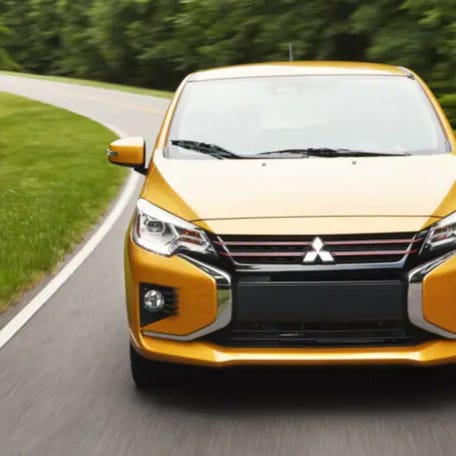 A yellow 2024 Mitsubishi Mirage is driving on the road. Courtesy Of Mitsubishi.