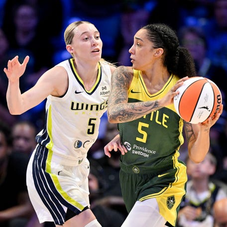 Seattle Storm forward Gabby Williams (5) looks to pass the ball as Dallas Wings guard Paige Bueckers (5) defends during their game on May, 19, 2025.