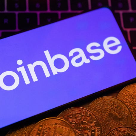 Smartphone with displayed Coinbase logo and representation of cryptocurrencies are placed on a keyboard in this illustration taken, June 8, 2023. REUTERS/Dado Ruvic/Illustration