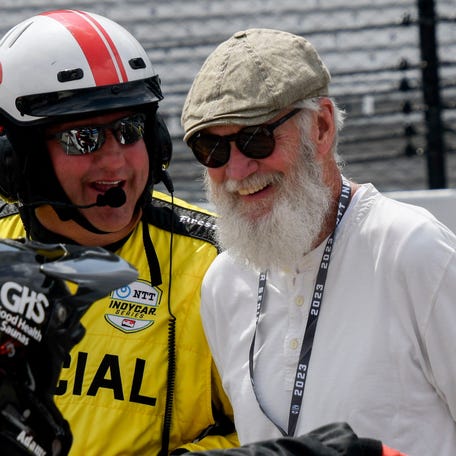 David Letterman laughs with a race official at the 2023 GMR Grand Prix at Indianapolis Motor Speedway.