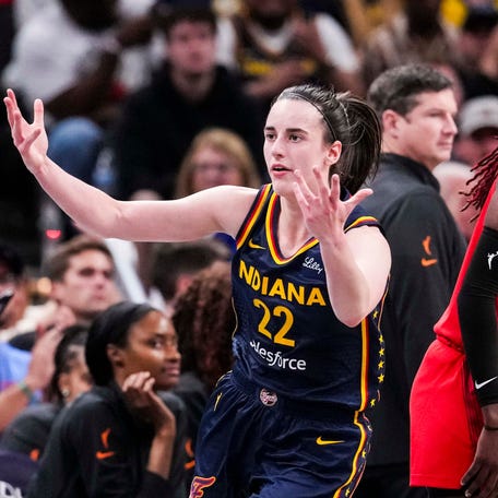 Indiana Fever guard Caitlin Clark (22) reacts after scoring a 3-pointer against Atlanta Dream guard Rhyne Howard (10) at Gainbridge Fieldhouse in Indianapolis on May 20, 2025.