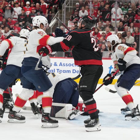 Florida Panthers forward Anton Lundell (15) defends against Carolina Hurricanes forward Sebastian Aho (20) during the first period of Game 1.