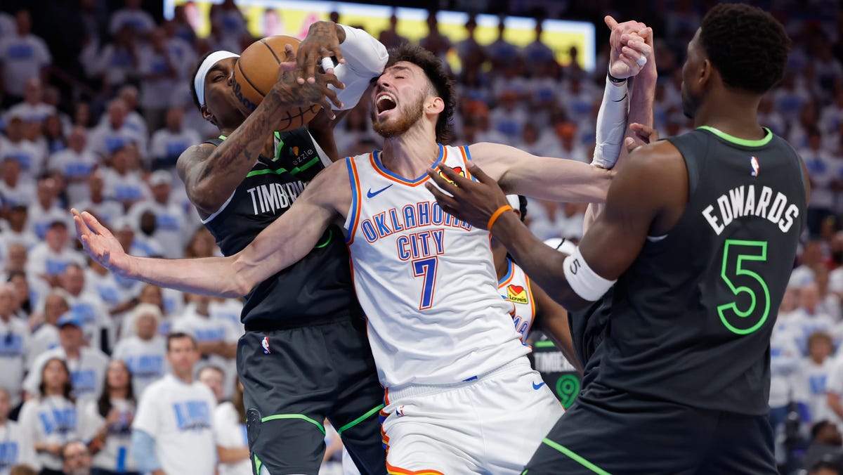 Thunder forward Chet Holmgren and Timberwolves forward Jaden McDaniels battle for a rebound during the fourth quarter of Game 1 of the Western Conference finals.