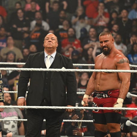 Seth Rollins (left) stands with Paul Heyman and Bron Breakker during WWE Raw at the T-Mobile Center on April 28, 2025.