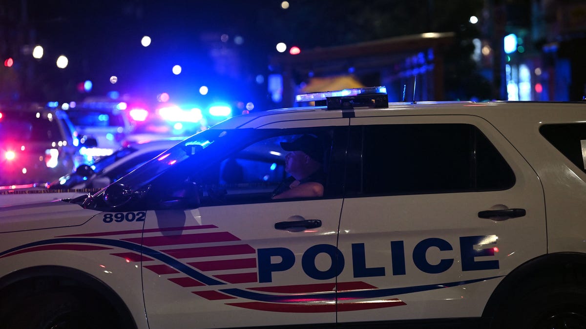 Police vehicles are pictured blocking a street after a shooting in Washington D.C.
