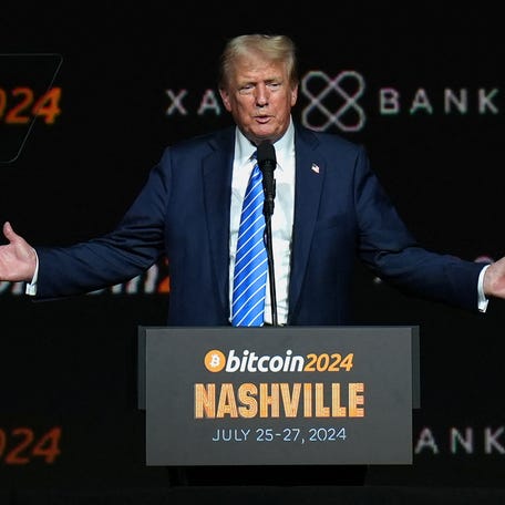 Then GOP presidential nominee Donald Trump gestures at the Bitcoin 2024 event in Nashville, Tennessee, U.S., July 27, 2024. Trump is hosting a dinner for investors in his cryptocurrency venture on May 22.