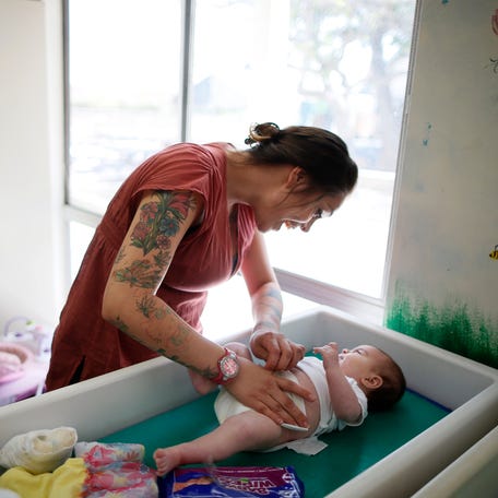 Vanessa Moreno, 24, changes the diapers of her two-month-old baby Makayla at Prototypes residential treatment program in Pomona, California, March 26, 2013. Prototypes is part of the Second Chance Women's Re-entry Court program, one of the first in the U.S. to focus on women. It offers a cost-saving alternative to prison for women who plead guilty to non-violent crimes and volunteer for treatment. Of the 297 women who have been through the court   since 2007, 100 have graduated, and only 35 have been returned to state prison. Picture taken March 26, 2013. REUTERS/Lucy Nicholson (UNITED STATES - Tags: SOCIETY CRIME LAW TPX IMAGES OF THE DAY)