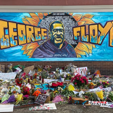 A makeshift memorial for George Floyd includes a mural, cards and flowers near the spot where he died while in police custody in Minneapolis.