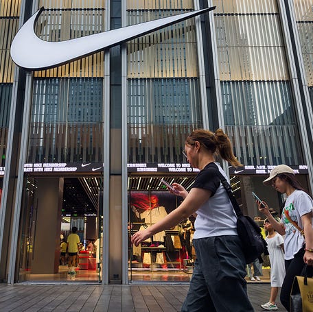 Pedestrians walk past a Nike store on April 12, 2025 in Shenzhen, China.