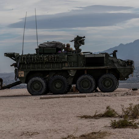 U.S. soldiers keep guard at the border wall in Sunland, New Mexico, in an area known for human smuggling by organized crime.