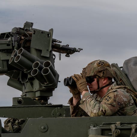 U.S. soldiers keep guard at the border wall in Sunland, New Mexico, in an area known for human smuggling by organized crime.