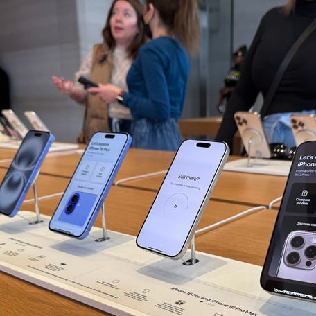 CHICAGO, ILLINOIS - APRIL 14: Customers shop iPhones at an Apple store on April 14, 2025 in Chicago, Illinois. Technology stocks got a boost today after President Donald Trump removed smartphones and other electronics from its tariffs on China over the weekend. (Photo by Scott Olson/Getty Images)
