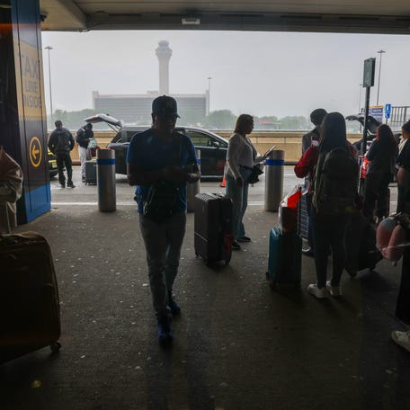 ravelers walk through Newark Liberty International Airport on one of the busiest travel days of the season on May 23, 2025, in Newark, New Jersey. (Photo by Spencer Platt/Getty Images)