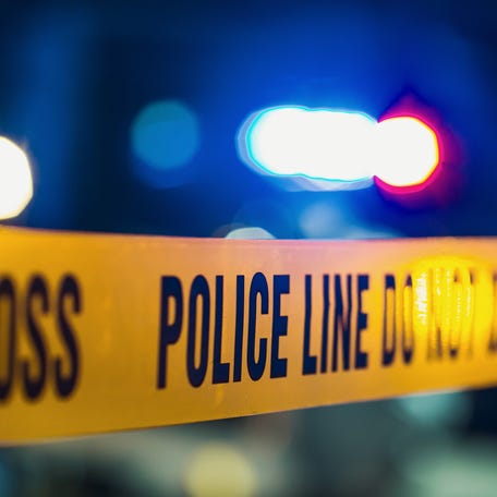 Close up shot focused on yellow tape showing text police line do not cross.
