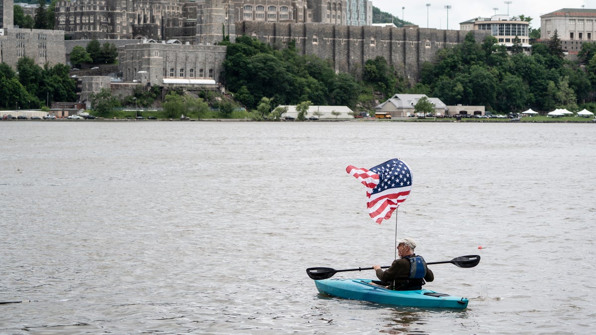 A kayaker with an American Flag makes its way out into the Hudson River from Garrison Landing across from the USMA at West Point during an anti-Trump in Garrison on Saturday, May 24, 2025.