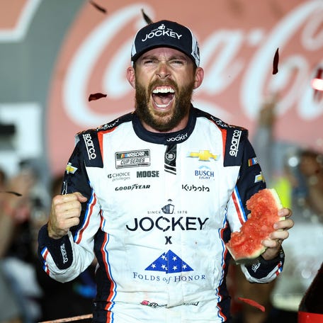 Ross Chastain celebrates in victory lane after winning the Coca-Cola 600.