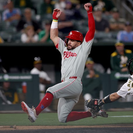 Kyle Schwarber scores a run against the Athletics.