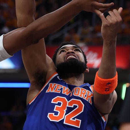 New York Knicks center Karl-Anthony Towns (32) shoots a layup past Indiana Pacers center Myles Turner (33) in Game 3 of the Eastern Conference finals.