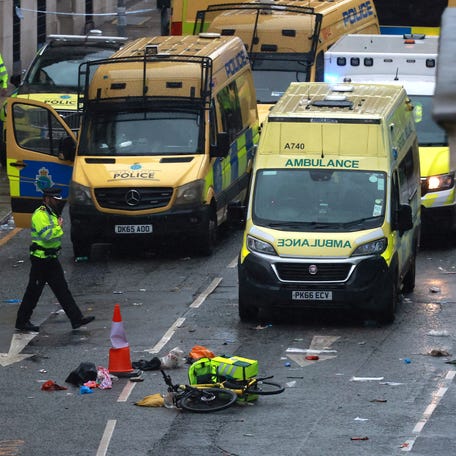 Emergency services vehicles are pictured at the scene after multiple people were hit by a car during Liverpool's Premier League title parade.
