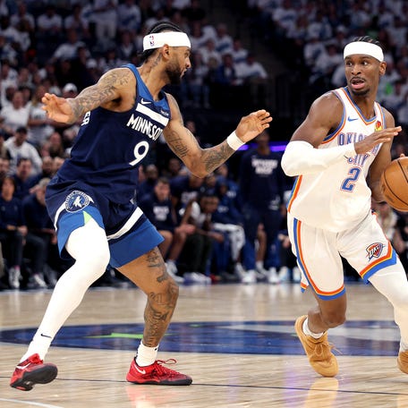 MINNEAPOLIS, MINNESOTA - MAY 26: Shai Gilgeous-Alexander #2 of the Oklahoma City Thunder drives to the basket against Nickeil Alexander-Walker #9 of the Minnesota Timberwolves during the third quarter in Game Four of the Western Conference Finals of the 2025 NBA Playoffs at Target Center on May 26, 2025 in Minneapolis, Minnesota.