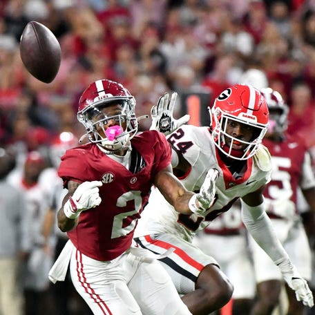Alabama Crimson Tide wide receiver Ryan Williams (2) makes a circus catch with Georgia Bulldogs defensive back Malaki Starks (24) defending at Bryant-Denny Stadium.