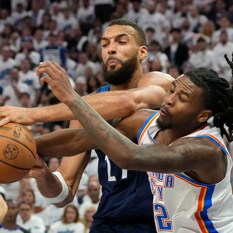 Game 4: The Minnesota Timberwolves' Rudy Gobert (left) attempts to shoot the ball against the Oklahoma City Thunder's Cason Wallace at Target Center. The Thunder won the game, 128-126.