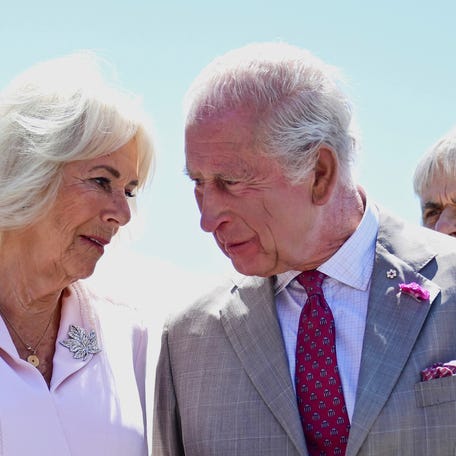 Britain's King Charles and Queen Camilla speak to each other as they arrive at Ottawa Airport in Ontario, Canada, on May 26, 2025. REUTERS
