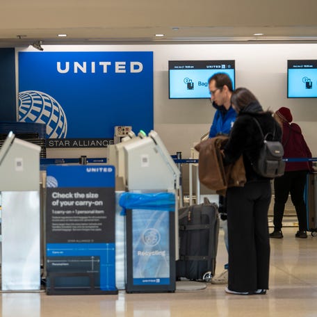 Holiday travelers check in for their flight with United Airlines the day before Thanksgiving at Newark International Airport on Wednesday, Nov. 27, 2024.