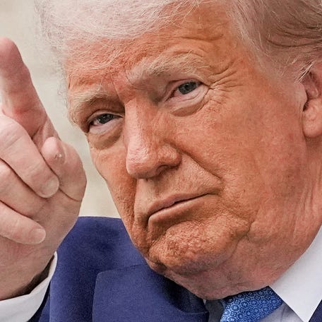 U.S. President Donald Trump gestures at the annual National Memorial Day Observance in the Memorial Amphitheater, at Arlington National Cemetery in Arlington, Virginia, U.S., May 26, 2025.