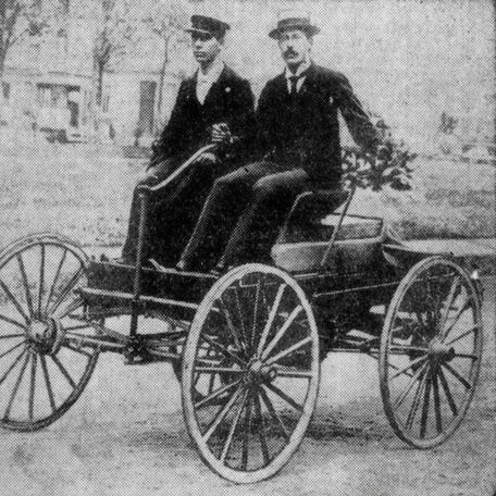 Charles Brady King at the controls of his first car.