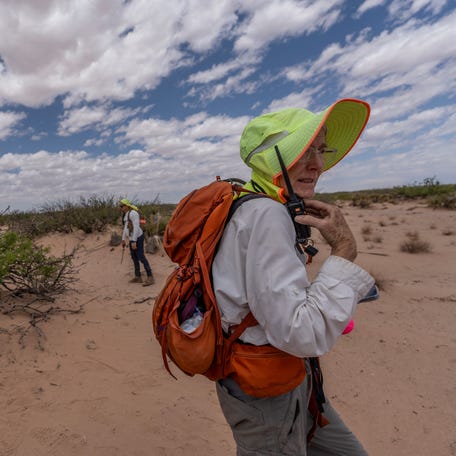 Abbey Carpenter, of Battalion Search and Rescue, communicates with volunteers over a radio during a search in Santa Teresa, New Mexico on May 17, 2025.