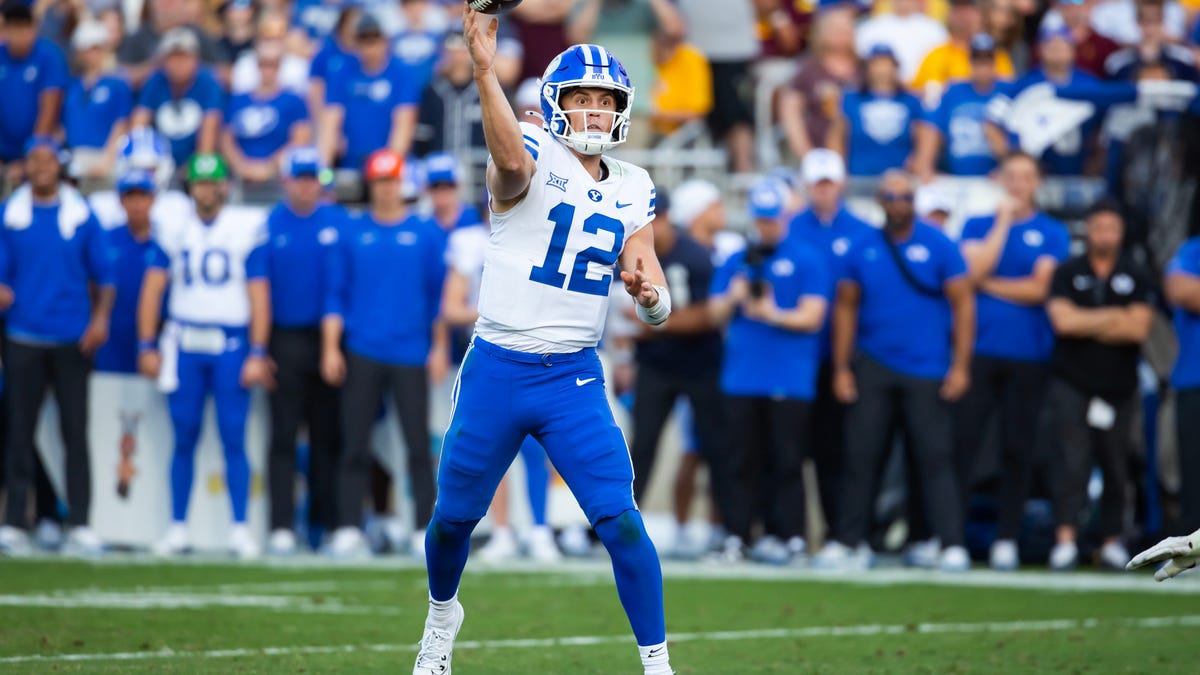 Nov 23, 2024; Tempe, Arizona, USA; Brigham Young Cougars quarterback Jake Retzlaff (12) against the Arizona State Sun Devils in the second half at Mountain America Stadium. Mandatory Credit: Mark J. Rebilas-Imagn Images