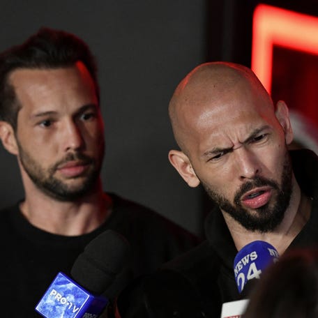 Tristan and Andrew Tate deliver a press statement in front of their house after landing back in Romania, near Bucharest, Romania, March 22, 2025.