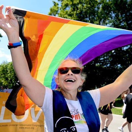 Susan Phillips, a pastor at First Presbyterian Church, carries a pride flag during the Pridefest parade on Saturday, May 17, 2025 in Springfield, Illinois.