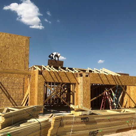 A worker builds a new home Aug. 28 on Dawn Drive in Far East El Paso. The home is being built by Desert View Homes, a large El Paso homebuilder.    Home Sales-2