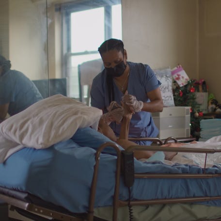 Zulma Torres, a professional caregiver in The Bronx, New York, cares for a client during the COVID-19 pandemic.