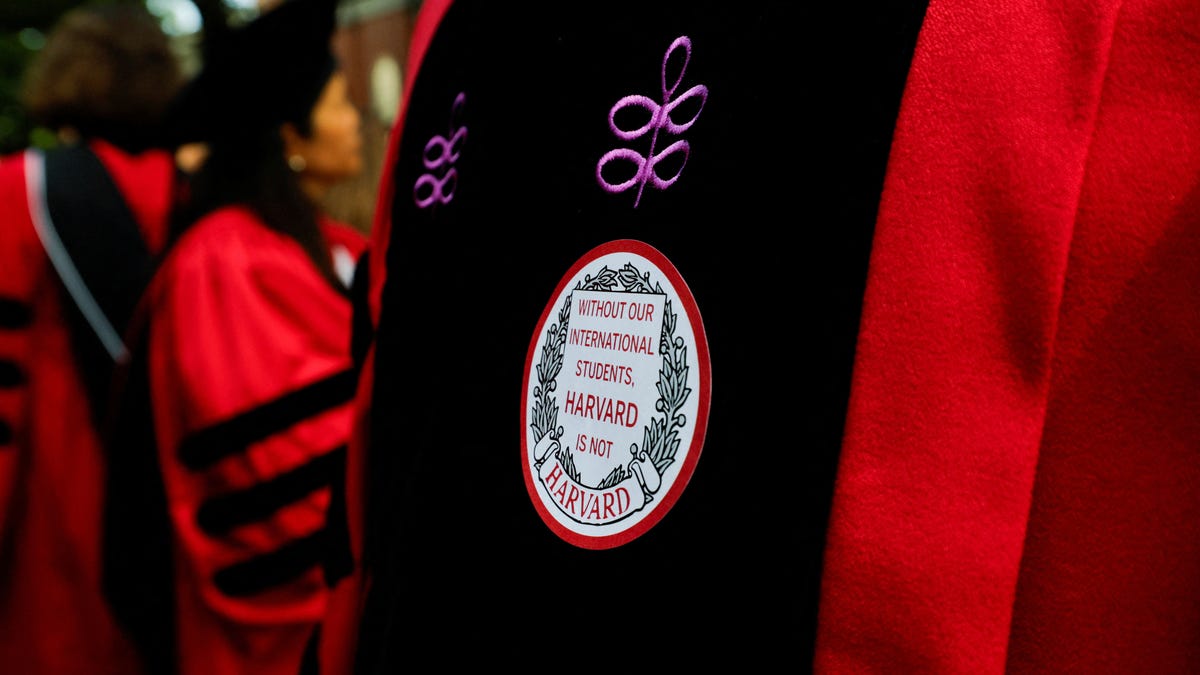 An attendee wears a sticker that reads "Without our international students, Harvard is not Harvard" during the 374th Commencement exercises at Harvard University in Cambridge, Massachusetts, U.S., May 29, 2025. REUTERS/Brian Snyder