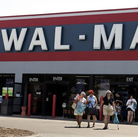 Shoppers exit a Walmart store in Casselberry, Florida June 22, 2004.