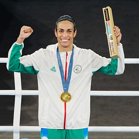 Imane Khelif celebrates with her gold medal at the 2024 Olympics.