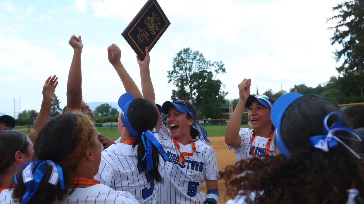 Middletown's Alyssa Platero hoist the Section 9 Class AAA softball Championship plaque after defeating Monroe-Woodbury on May 30, 2025.