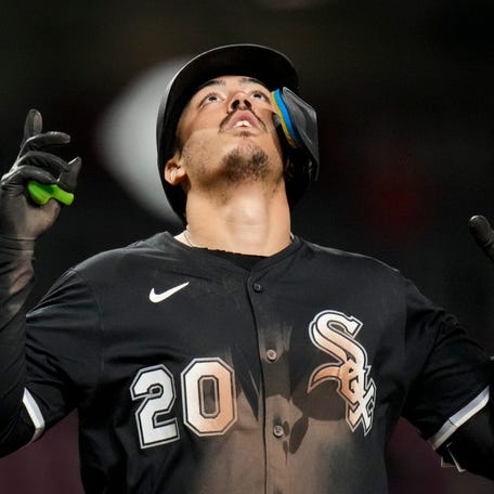 Miguel Vargas celebrates a home run in extra innings against the Reds.