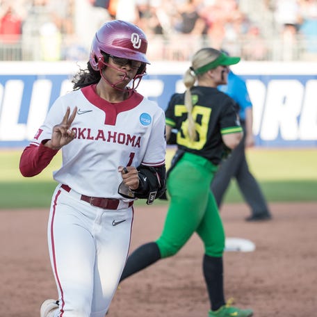 Jun 1, 2025; Oklahoma City, OK, USA; Oklahoma Sooners first baseman Cydney Sanders (1) holds up two fingers as she rounds the bases after a two run home run in the third inning against the Oregon Ducks during the WCWS at Devon Park. Mandatory Credit: Brett Rojo-Imagn Images