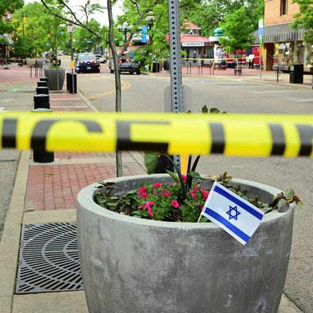 An Israeli flag is placed near police tape in Boulder, Colorado, on June 1, 2025. A suspect who authorities say attacked a pro-Israel event, leaving eight people with burn injuries, told investigators he "wanted to kill all Zionist people" and would launch another assault if he was able to, a federal affidavit said. Investigators say the suspect hurled Molotov cocktails into a crowd and used a makeshift flamethrower to   attack people advocating for the release of Israeli hostages in Gaza.