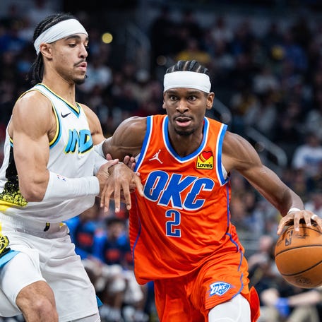 Oklahoma City Thunder guard Shai Gilgeous-Alexander (2) dribbles the ball while Indiana Pacers guard Andrew Nembhard (2) defends at Gainbridge Fieldhouse on Dec. 26, 2024.