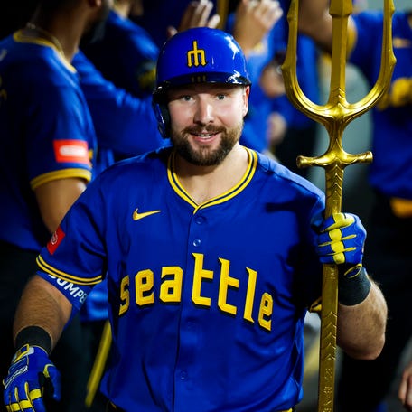 May 30, 2025; Seattle, Washington, USA; Seattle Mariners catcher Cal Raleigh (29) celebrates in the dugout after hitting a two-run home run against the Minnesota Twins during the eighth inning at T-Mobile Park. Mandatory Credit: Joe Nicholson-Imagn Images