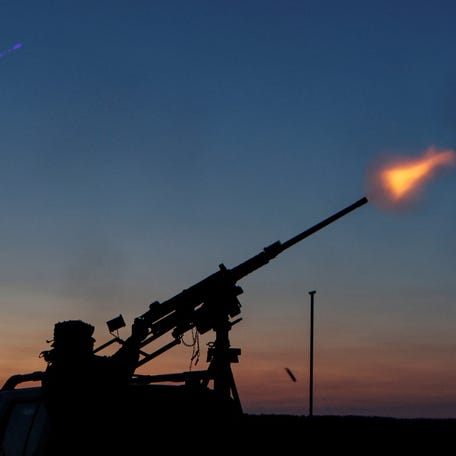 A serviceman from the mobile air defence unit of the 115th Separate Mechanized Brigade of the Ukrainian Armed Forces fires a Browning machine gun towards a Russian drone during an overnight shift, amid Russia's attack on Ukraine, in Kharkiv Region, Ukraine June 2, 2025. REUTERS/Sofiia Gatilova